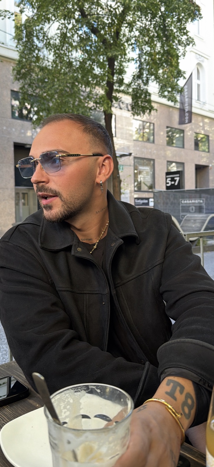 Ein ruhiger Moment im Straßencafé mit Sonnenbrille und Kaffee